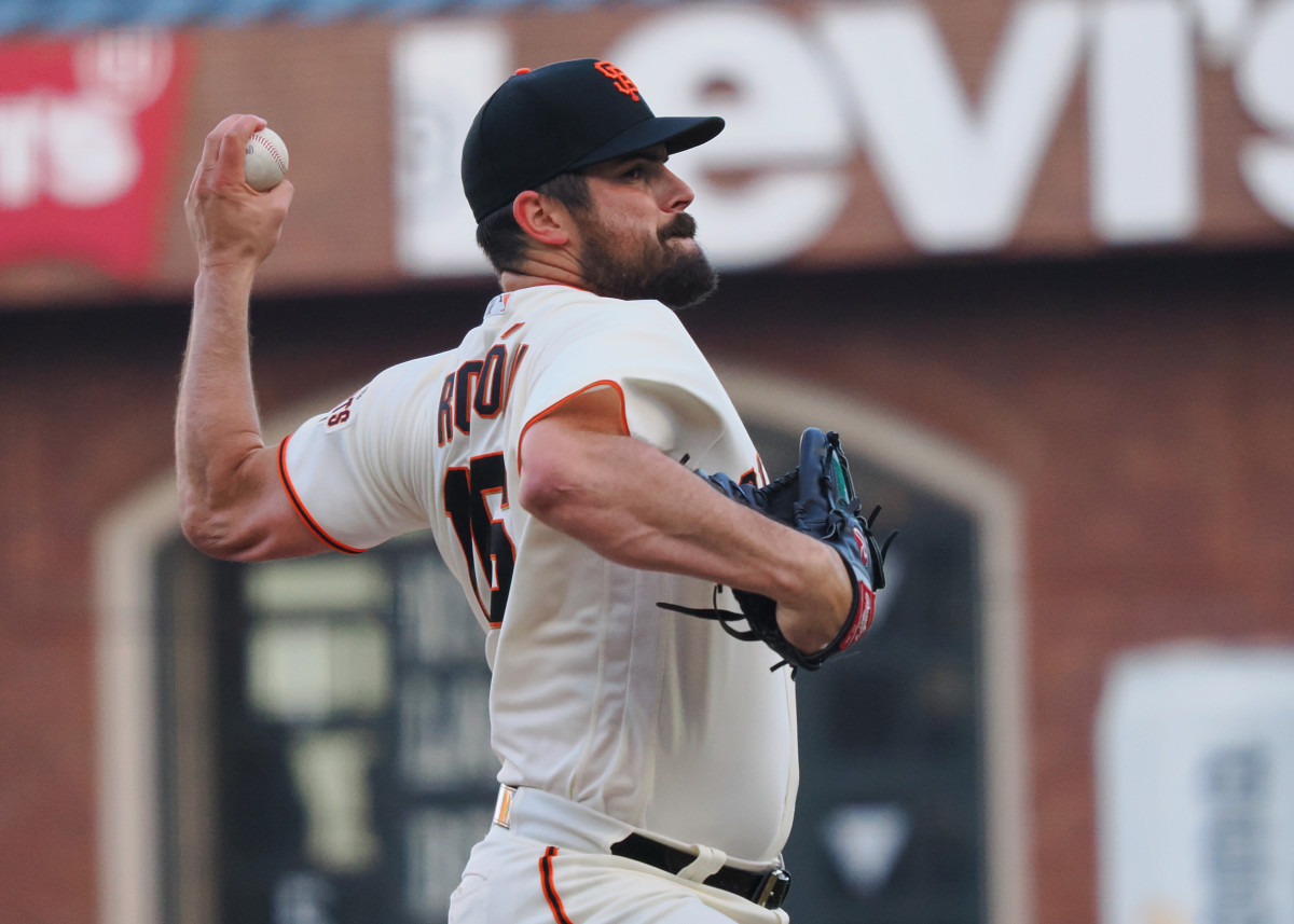 San Francisco Giants starting pitcher Carlos Rodon winds up holding a baseball