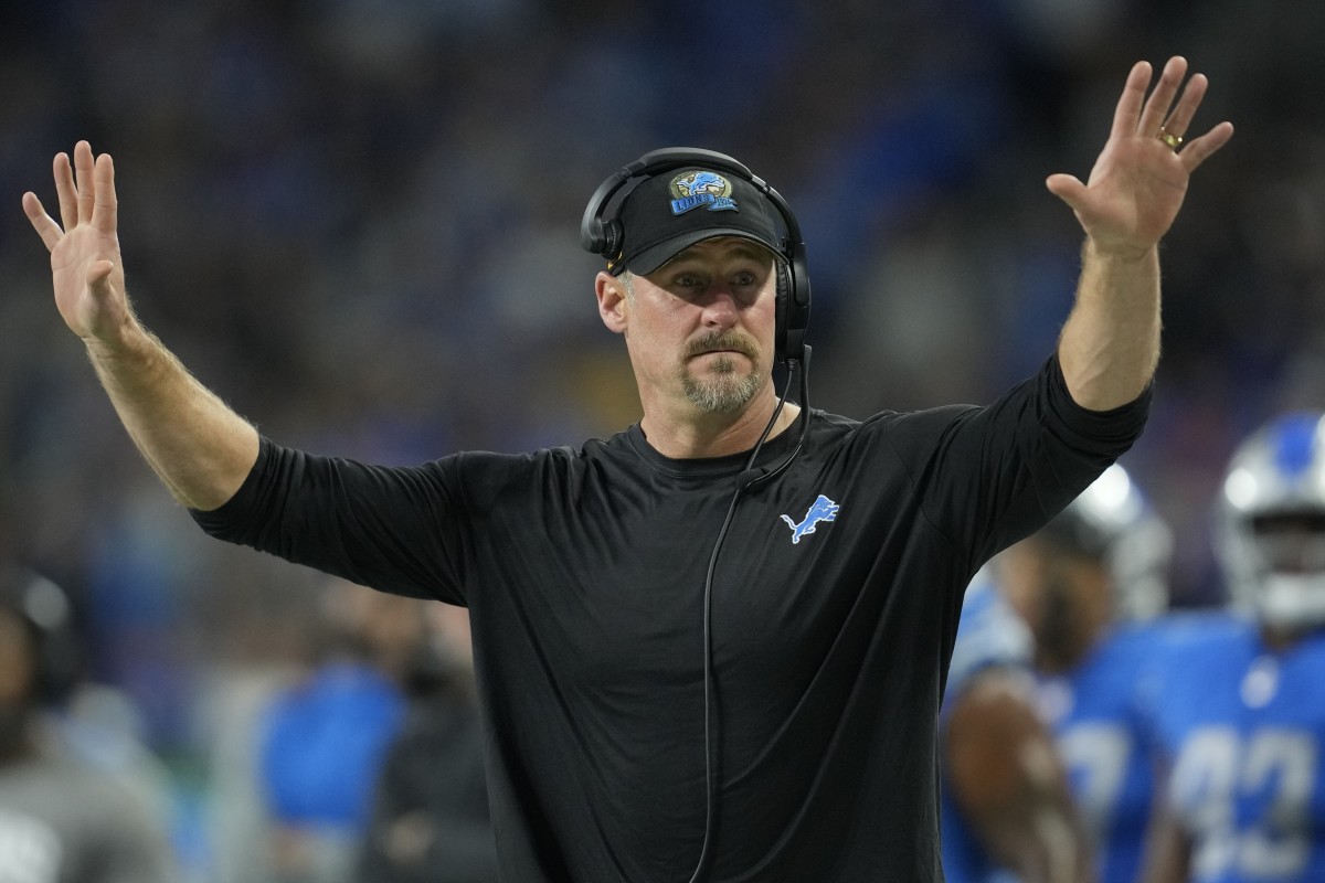 Dan Campbell gestures with two hands up on the sideline during the Lions' win over the Vikings