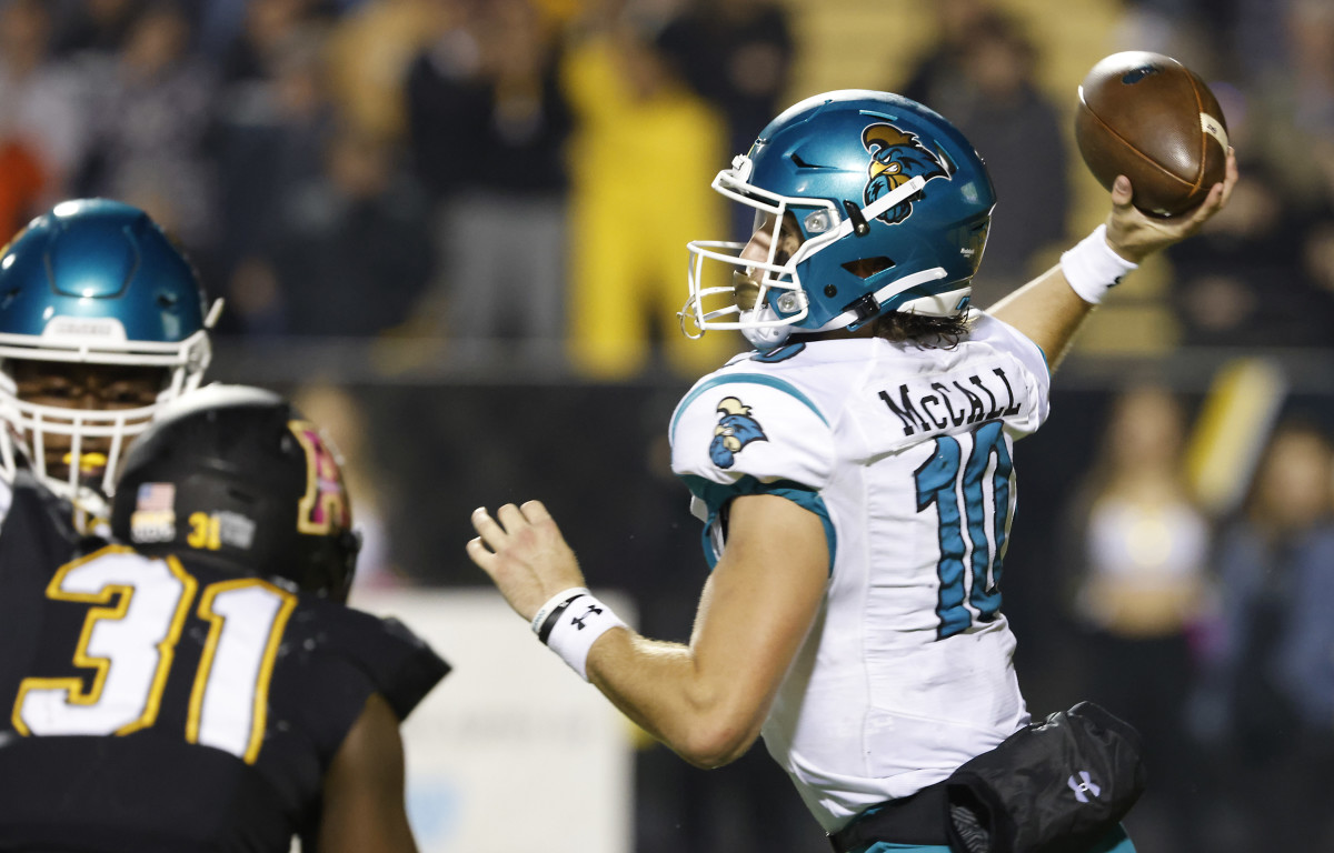 Oct 20, 2021; Boone, North Carolina, USA; Coastal Carolina Chanticleers quarterback Grayson McCall (10) throws a pass under pressure from Appalachian State Mountaineers defensive lineman Zareon Hayes (30) during the second half at Kidd Brewer Stadium. Mandatory Credit: Reinhold Matay-USA TODAY Sports