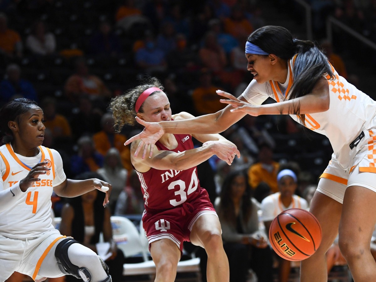 Indiana guard Grace Berger (34) passes the ball off while guarded Tennessee guard Jordan Walker (4) and center Tamari Key (20) during an NCAA college basketball game between the Tennessee Lady Vols and Indiana Hoosiers on Monday, November 14, 2022 in Knoxville, Tenn.