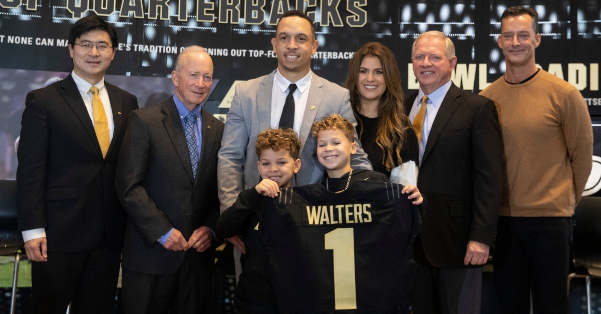Purdue football head coach Ryan Walters poses for a photo with family and members of Purdue during a press conference introducing him as the new head coach, Wednesday, Dec. 14, 2022, at the Kozuch Football Performance Complex in West Lafayette, Ind.