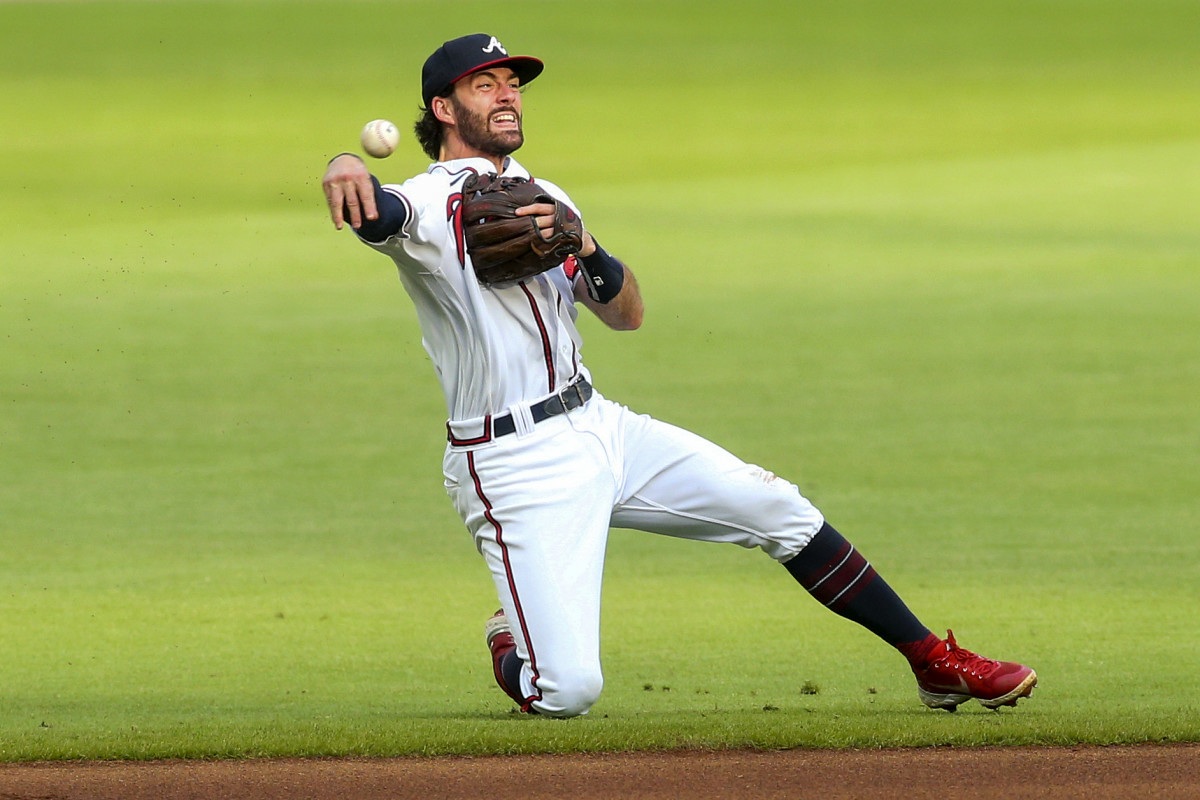 Braves shortstop Dansby Swanson throws to first base.