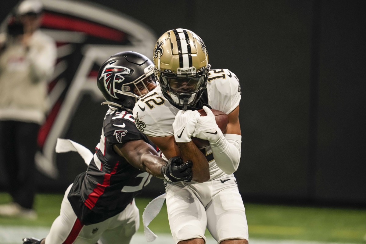 New Orleans Saints receiver Chris Olave (12) catches a two point conversion in front of Atlanta Falcons safety Jaylinn Hawkins (32). Mandatory Credit: Dale Zanine-USA TODAY Sports