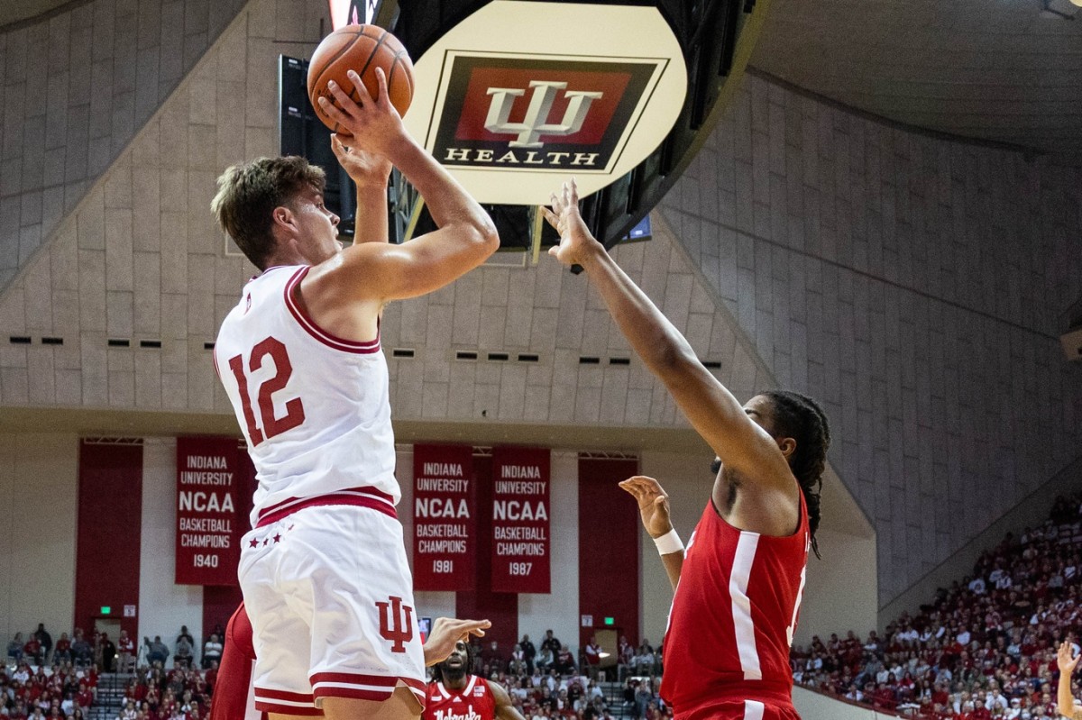 Indiana Hoosiers forward Miller Kopp (12) shoots the ball while Nebraska Cornhuskers guard Denim Dawson (12) defends in the first half at Simon Skjodt Assembly Hall.