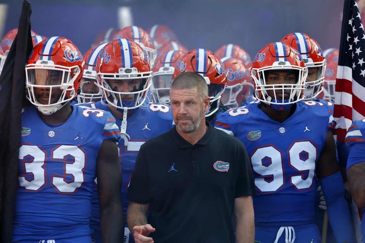 Gainesville, Florida, USA; Florida Gators head coach Billy Napier run out of the tunenl withlinebacker Lloyd Summerall III (99), defensive lineman Princely Umanmielen (33) and teammates prior to the game against the South Carolina Gamecocks at Ben Hill Griffin Stadium.
