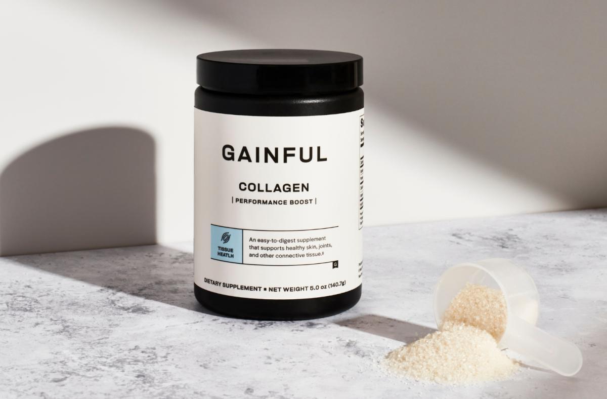 A black and white container of Gainful collagen powder next to a scoop of collagen powder