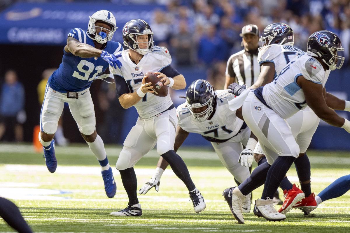 Oct 2, 2022; Indianapolis, Indiana, USA; Tennessee Titans quarterback Ryan Tannehill (17) narrowly misses being sacked by Indianapolis Colts defensive end Yannick Ngakoue (91) during the first quarter at Lucas Oil Stadium.
