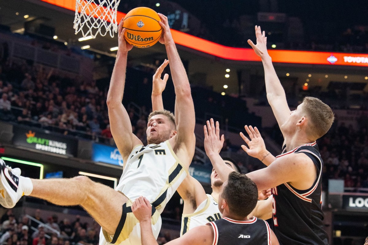 Dec 17, 2022; Indianapolis, Indiana, USA; Purdue Boilermakers forward Caleb Furst (1) rebounds the ball while Davidson Wildcats forward David Skogman (42) defends in the second half at Gainbridge Fieldhouse.