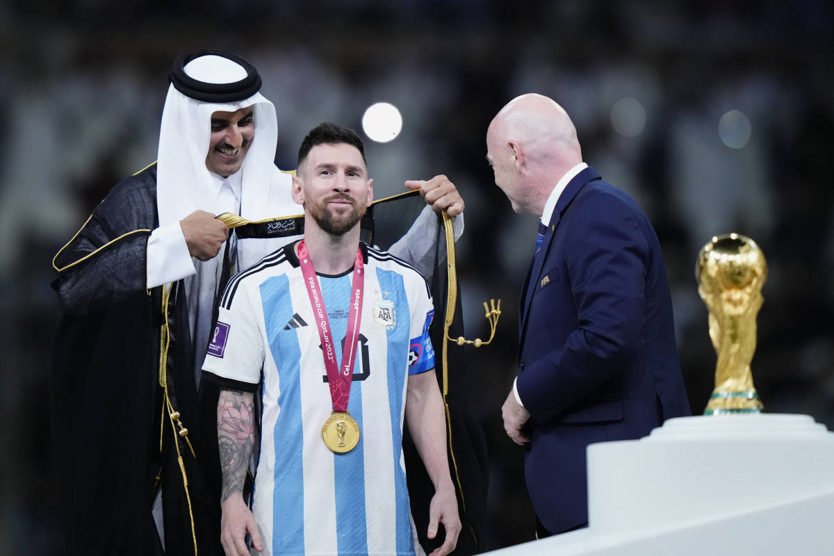 Lionel Messi pictured being dressed in a traditional Arab bisht before he lifted the World Cup trophy as captain of Argentina