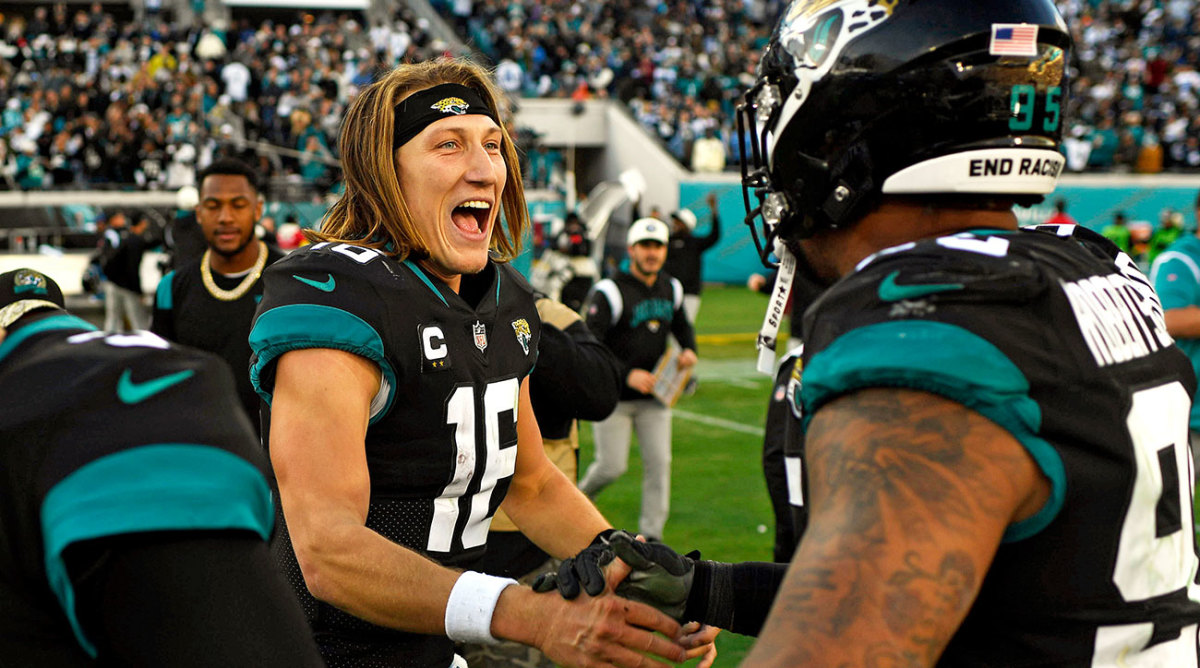 Trevor Lawrence celebrates on the field after beating the Cowboys in Week 15.