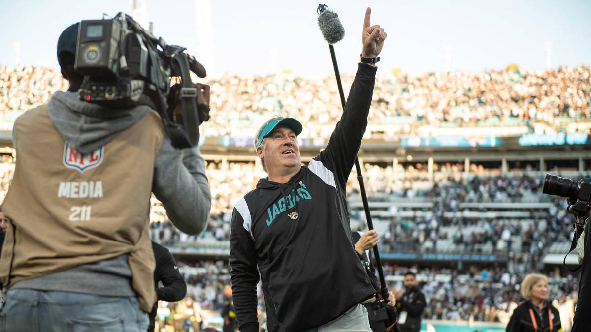 Doug Pederson gestures "No. 1" to the crowd as he leaves the field after beating the Cowboys