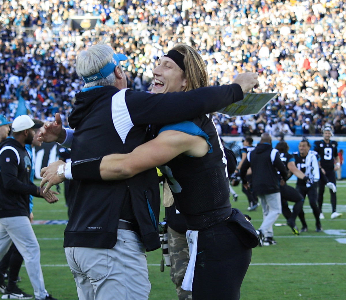 Doug Pederson and Trevor Lawrence embrace after the Jaguars' victory over the Cowboys