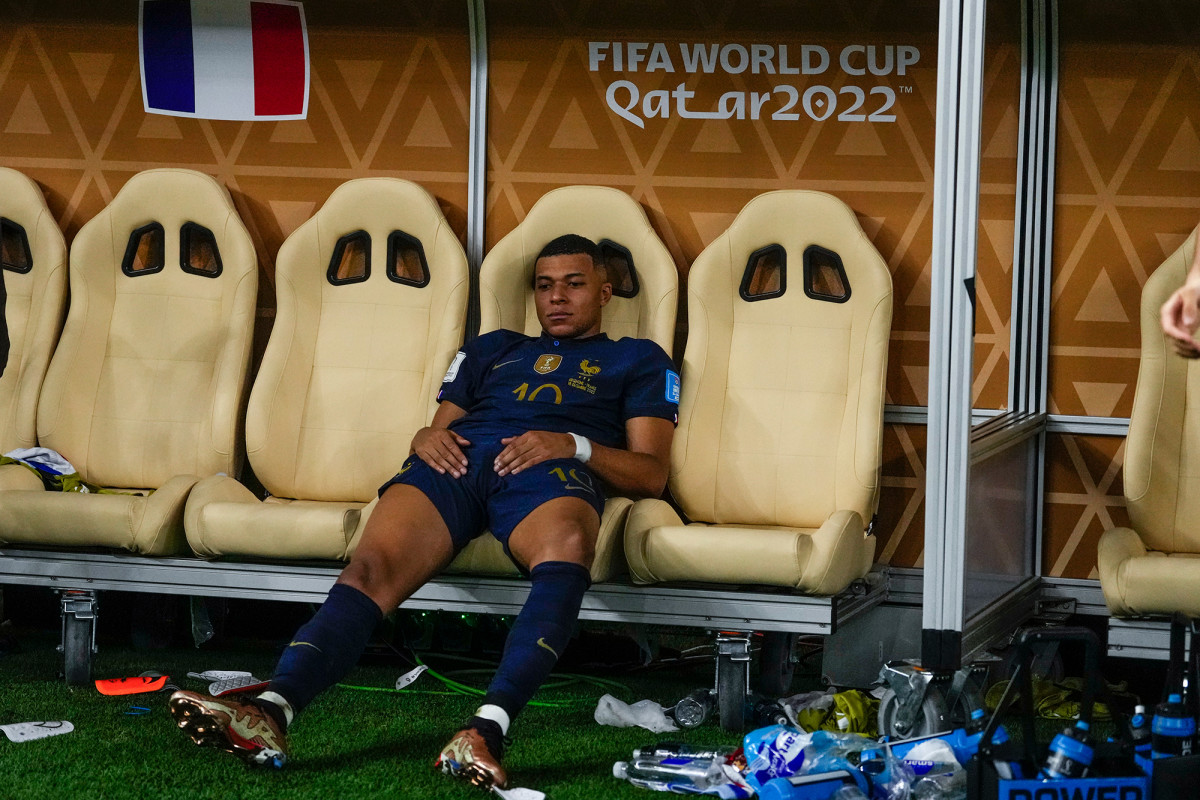 Kylian Mbappe sits in sadness on the France bench after losing the World Cup final