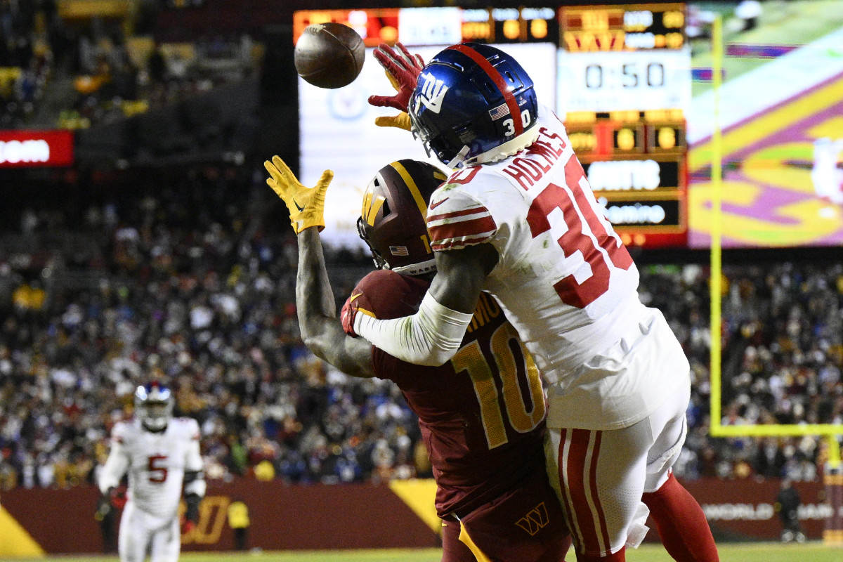 New York Giants cornerback Darnay Holmes (30) defends Washington Commanders wide receiver Curtis Samuel (10) on fourth down to seal a 20-12 victory, Sunday, Dec. 18, 2022, in Landover, Md.