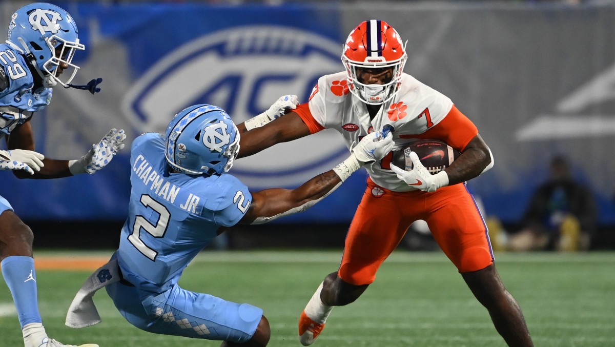 Clemson Tigers running back Kobe Pace (7) stiff arms North Carolina Tar Heels defensive back Don Chapman (2) during the fourth quarter of the ACC Championship game at Bank of America Stadium.