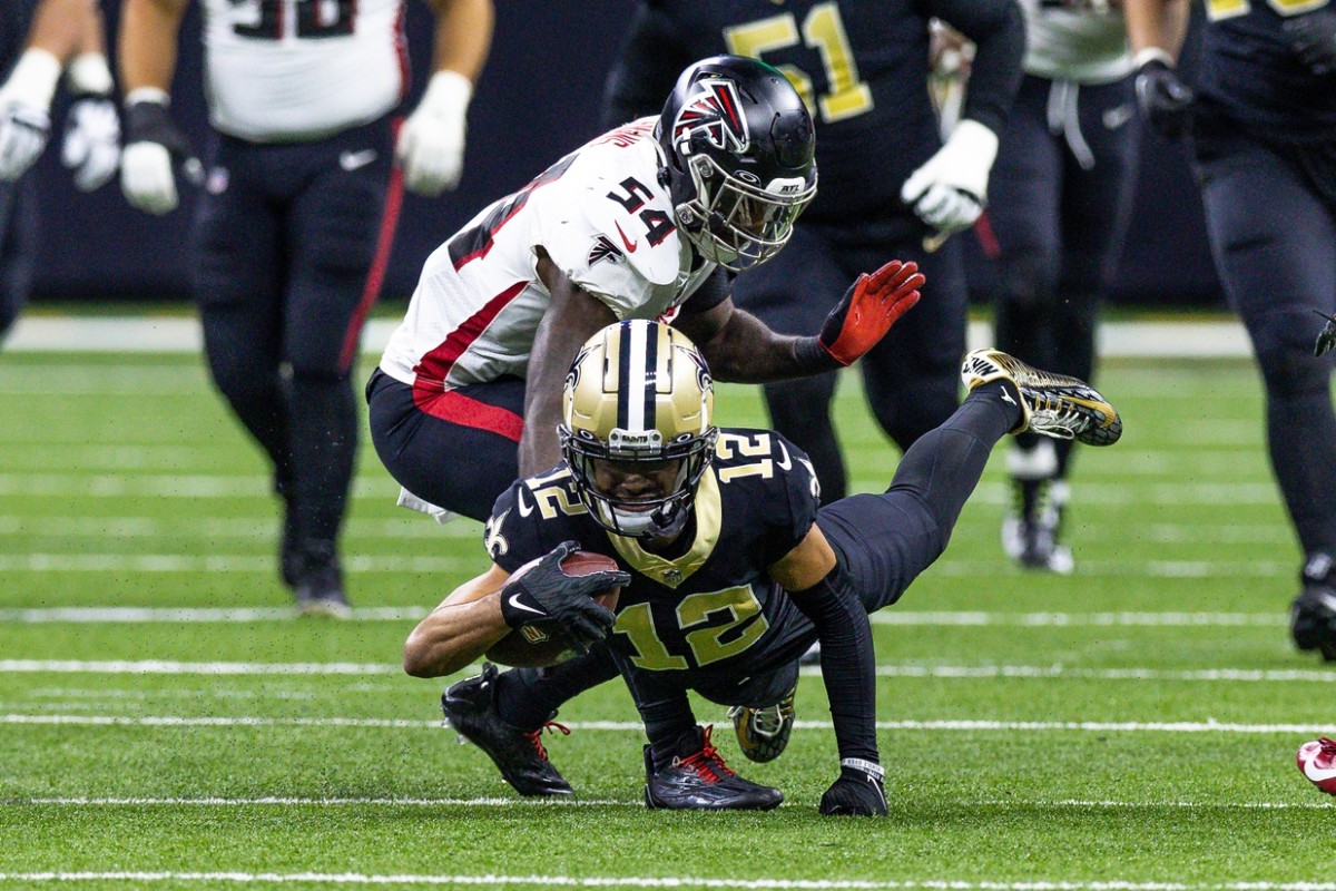 New Orleans Saints receiver Chris Olave (12) dives for extra yards against the Atlanta Falcons linebacker Rashaan Evans (54). Mandatory Credit: Stephen Lew-USA TODAY Sports