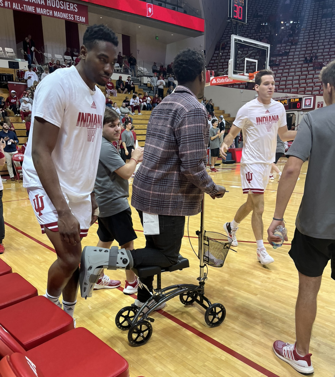 Indiana point guard Xavier Johnson with a walking boot and scooter during pregame warmups on Tuesday against Elon at Simon Skjodt Assembly Hall.
