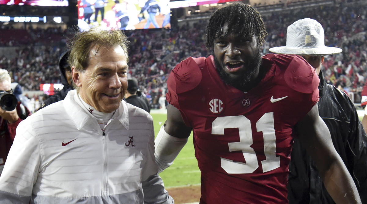 Alabama coach Nick Saban and linebacker Will Anderson walk off the field together after defeating Auburn