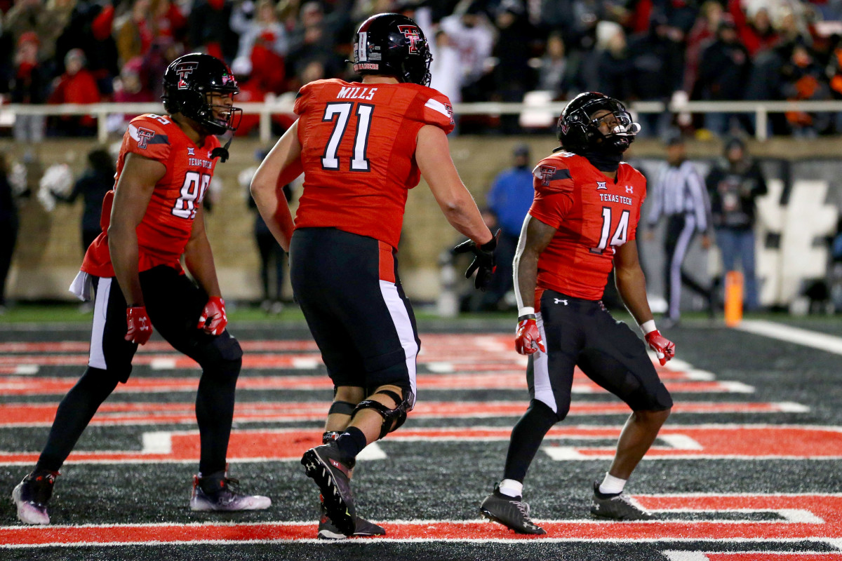 Texas, USA; Texas Tech Red Raiders wide receiver Xavier White (14) celebrates with offensive tackle Monroe Mills (71) and tight end Braden York (89) after scoring a touchdown against the Oklahoma Sooners in the second half at Jones AT&T Stadium and Cody Campbell Field