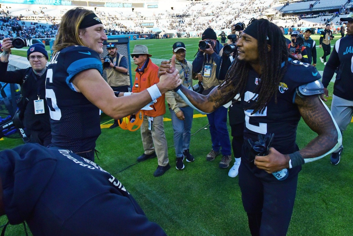 Jaguars quarterback Trevor Lawrence congratulates safety Rayshawn Jenkins after Jenkins's interception for a touchdown in overtime lifted Jacksonville past the Cowboy in Week 15.