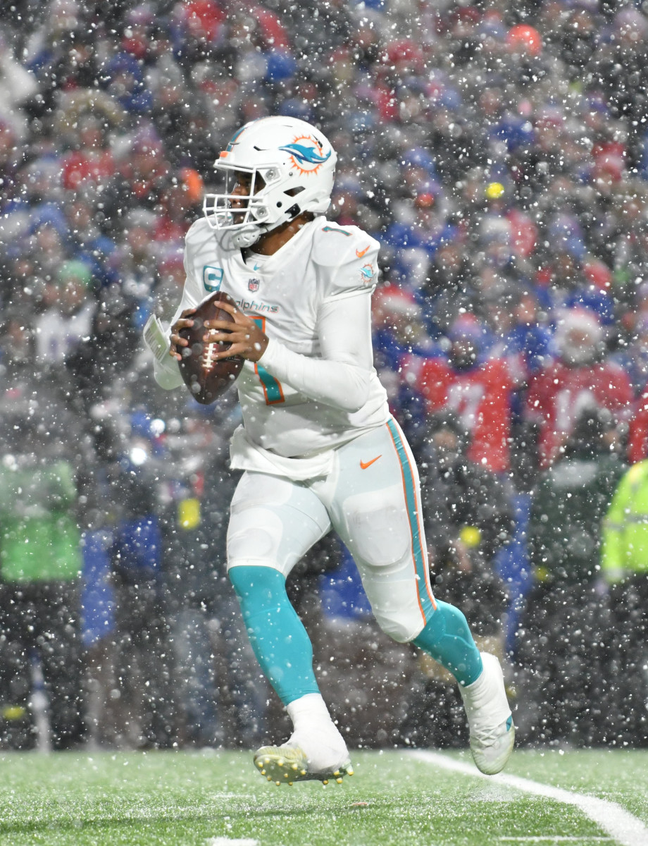 Miami Dolphins quarterback Tua Tagovailoa (1) rolls out of the pocket against the Buffalo Bills in the fourth quarter at Highmark Stadium.