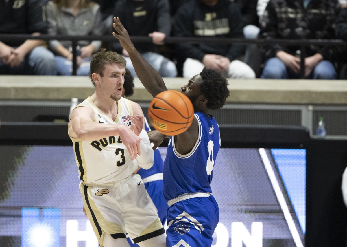 Dec 21, 2022; West Lafayette, Indiana, USA; Purdue Boilermakers guard Braden Smith (3) passes the ball around New Orleans Privateers guard Daniel Sackey (0) during the first half at Mackey Arena.