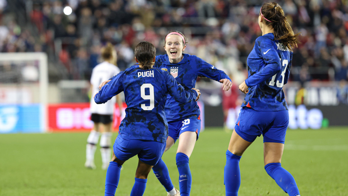 Mallory Pugh celebrates scoring a goal with Rose Lavelle and Alex Morgan.