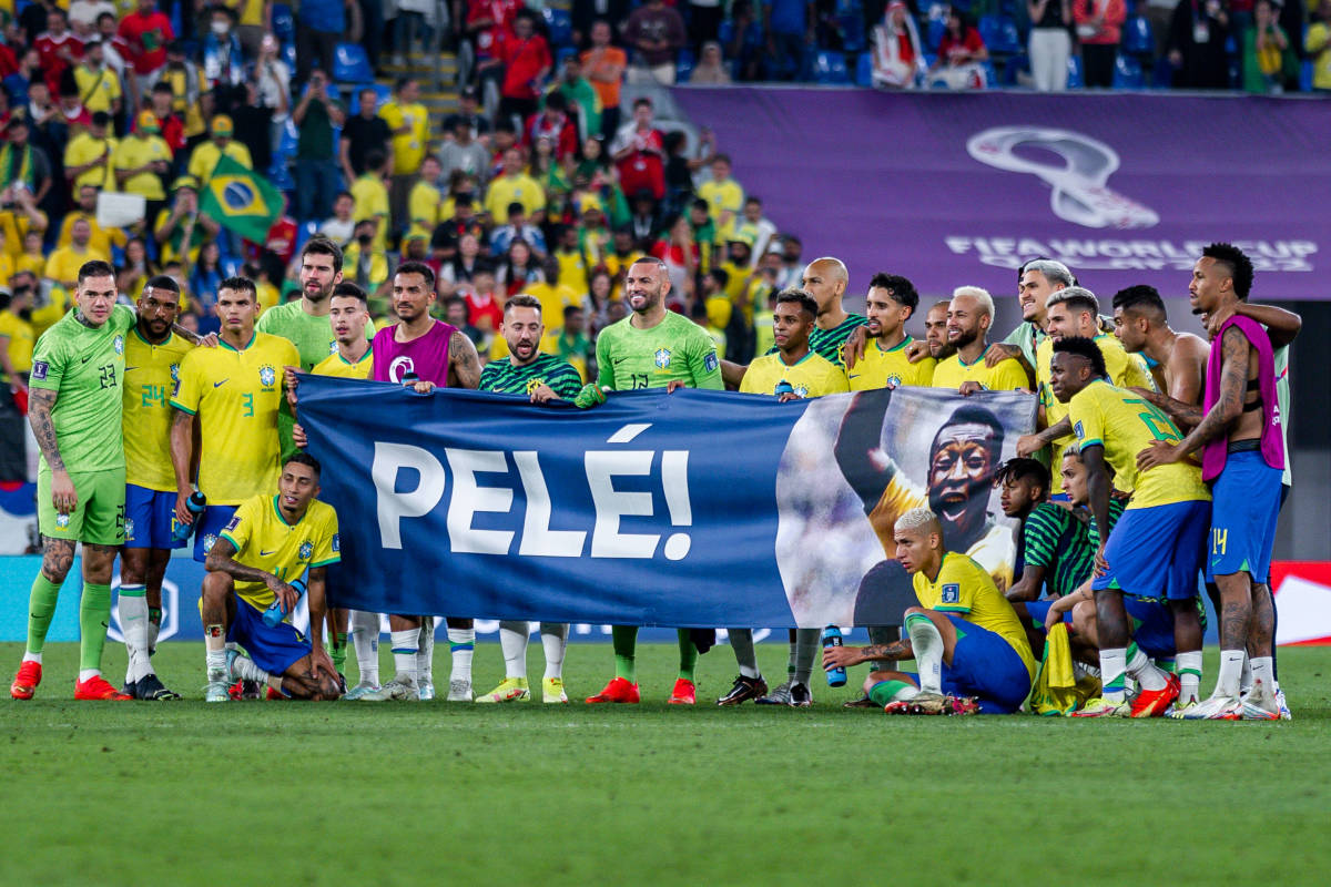 Players of Brazil pictured holding up a banner to show support for unwell national icon Pele during the 2022 World Cup