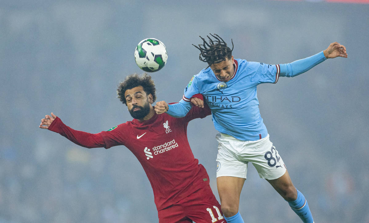 Mo Salah (left) and Rico Lewis pictured competing for the ball during Manchester City's 3-2 win over Liverpool