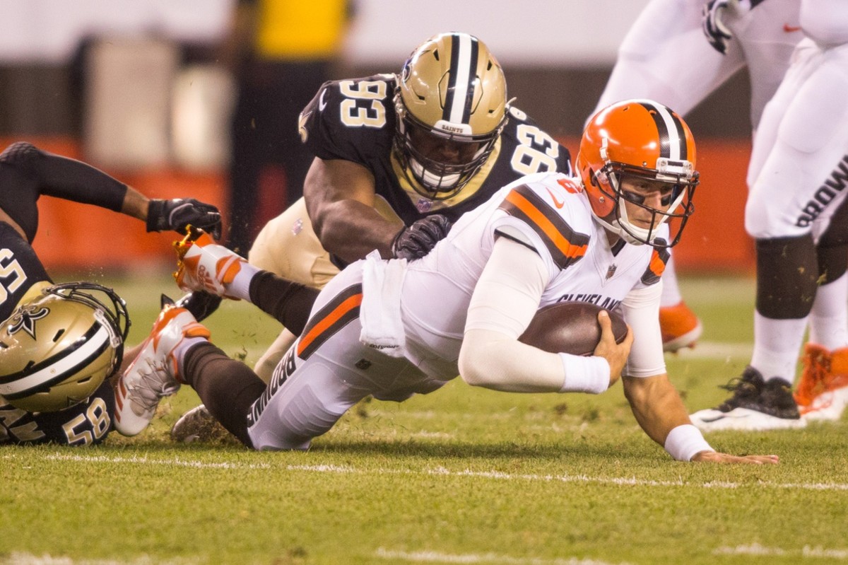 Aug 10, 2017; Cleveland Browns quarterback Cody Kessler (6) gets tackled by New Orleans Saints defensive tackle David Onyemata (93) during a preseason game. Mandatory Credit: Scott R. Galvin-USA TODAY Sports