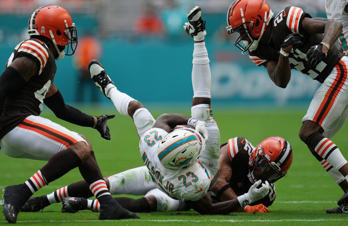 Miami Dolphins Elijah Campbell (22) gets up-ended by Cleveland Browns safety Grant Delpit (22). © JIM RASSOL/THE PALM BEACH POST / USA TODAY NETWORK
