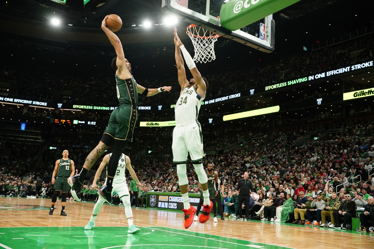 Boston Celtics small forward Jayson Tatum (0) dunks the ball against Milwaukee Bucks power forward Giannis Antetokounmpo (34)