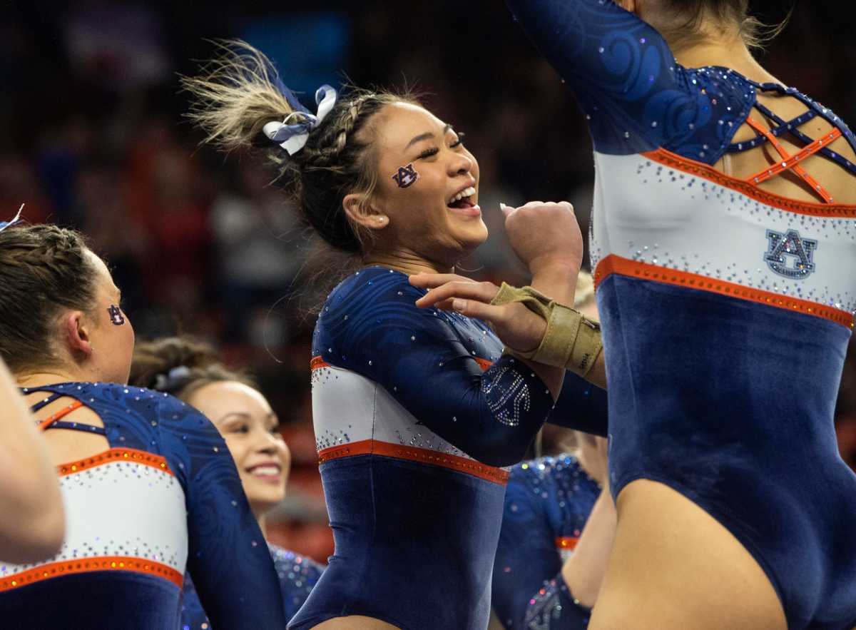 Auburn's Suni Lee celebrates after getting a perfect score for her bar routine as Auburn Tigers gymnastics takes on Florida Gators at Neville Arena in Auburn, Ala., on Friday, March 4, 2022. Auburn Tigers and Florida Gators ended in a tie at 198.575.