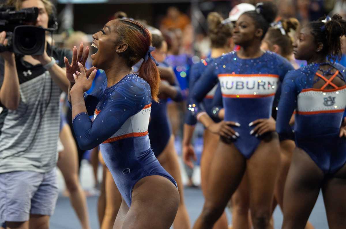 Auburn's Derrian Gobourne celebrates after her floor routine as Auburn Tigers gymnastics takes on Florida Gators at Neville Arena in Auburn, Ala., on Saturday, March 5, 2022. Auburn Tigers and Florida Gators ended in a tie at 198.575.