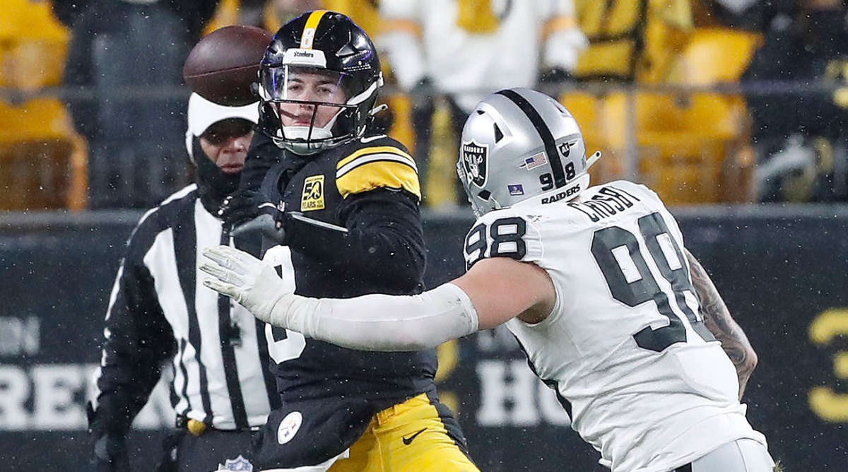 Kenny Pickett throws a pass against the Raiders on Christmas Eve