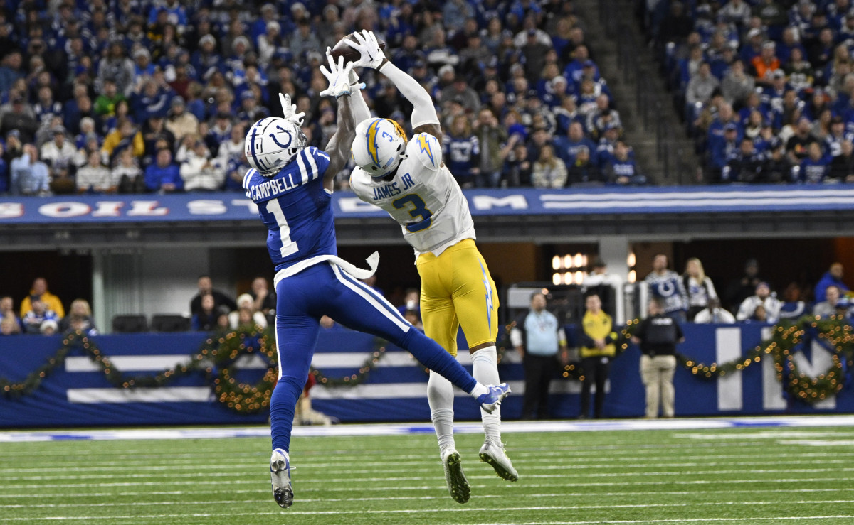Dec 26, 2022; Indianapolis, Indiana, USA; Los Angeles Chargers safety Derwin James Jr. (3) intercepts a pass meant for Indianapolis Colts wide receiver Parris Campbell (1) during the first quarter at Lucas Oil Stadium.