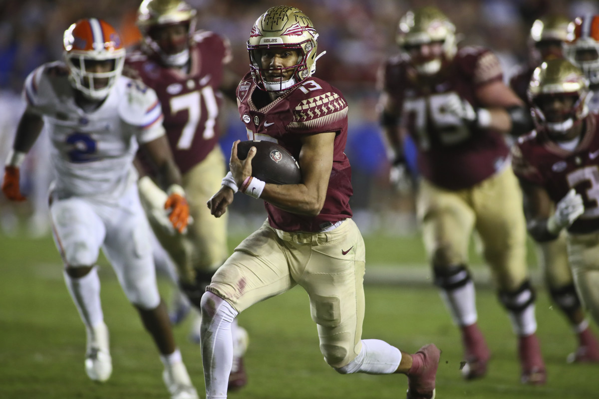 Florida State quarterback Jordan Travis (13) runs on a keeper during the fourth quarter of the team's NCAA college football game against Florida on Friday, Nov. 25, 2022, in Tallahassee, Fla. Florida State won 45-38.