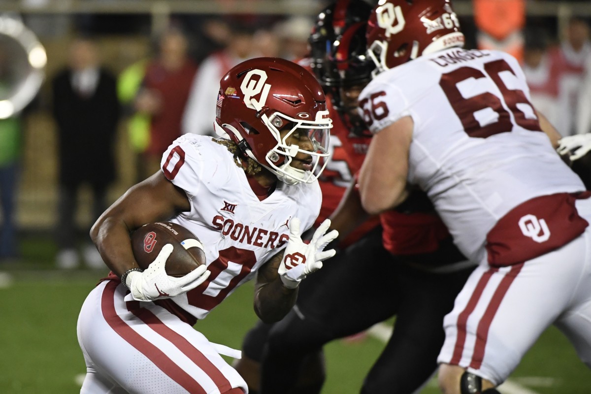 Oklahoma running back Eric Gray (0) carries against Texas Tech during the first half of an NCAA college football game Saturday, Nov. 26, 2022, in Lubbock, Texas.