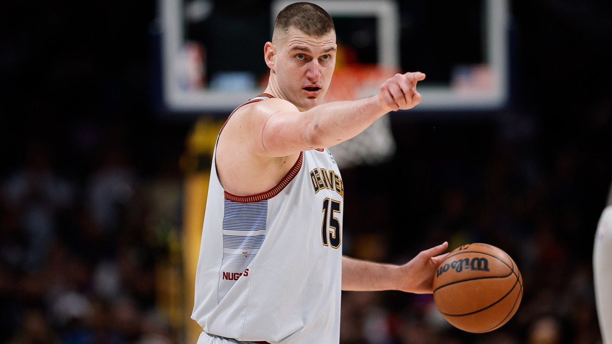 Nikola Jokic points to a player before making a pass.