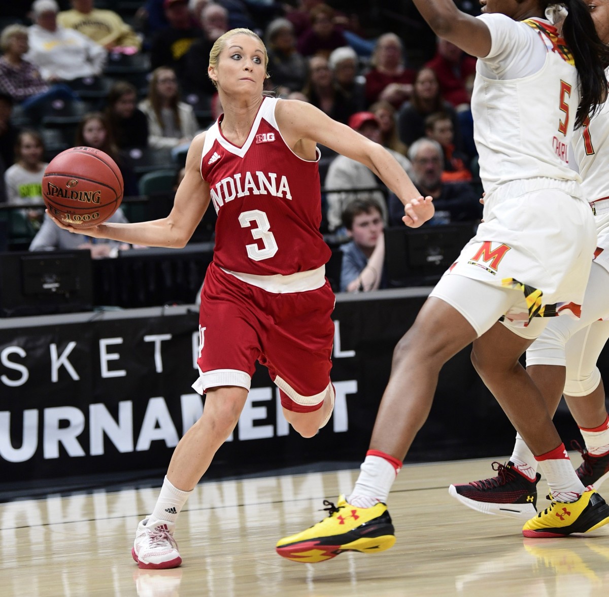 Mar 2, 2018; Indianapolis, IN, USA; Indiana Hoosiers guard Tyra Buss (3) winds up to pass the ball around some Maryland Terrapins in the first period during the third round of the Big Ten Conference Tournament at Bankers Life Fieldhouse.