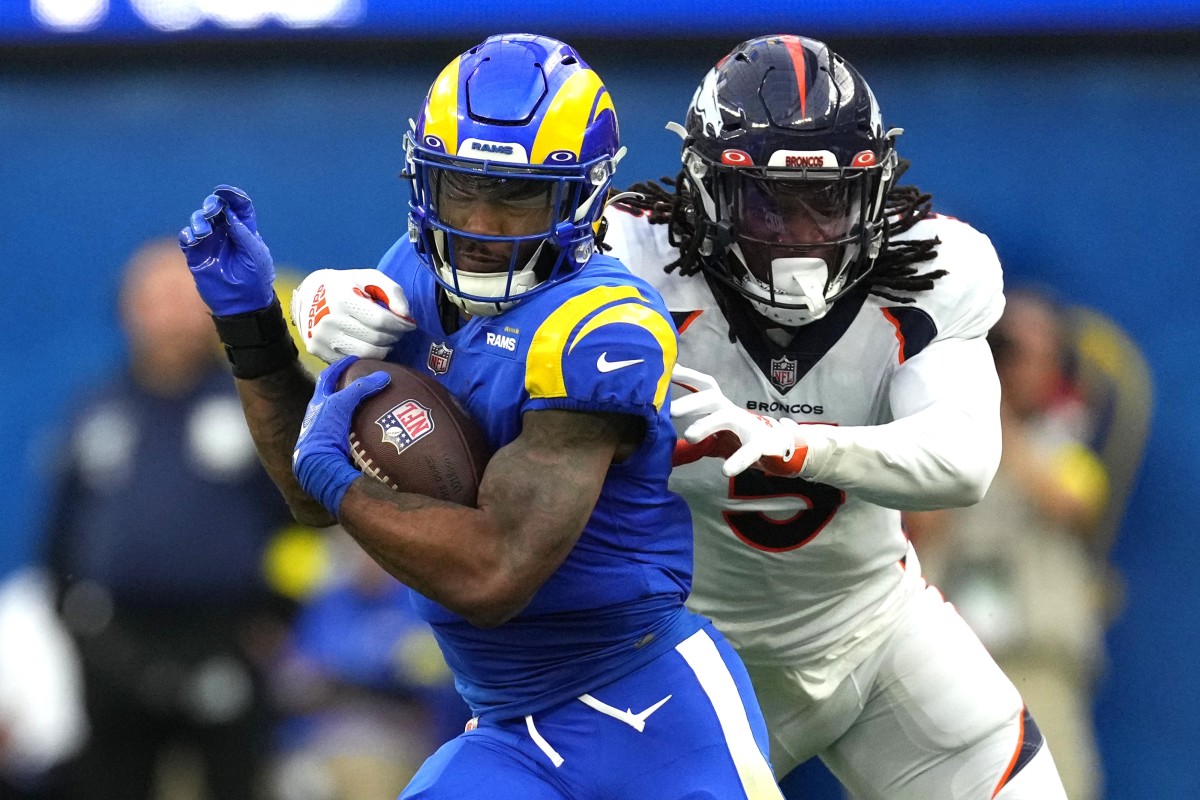 Los Angeles Rams running back Cam Akers (3) carries the ball against Denver Broncos linebacker Randy Gregory (5) in the first half at SoFi Stadium.