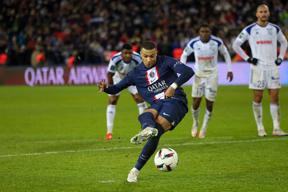 Kylian Mbappe pictured converting a penalty kick to give PSG a 2-1 win over Strasbourg in Ligue 1 in December 2022