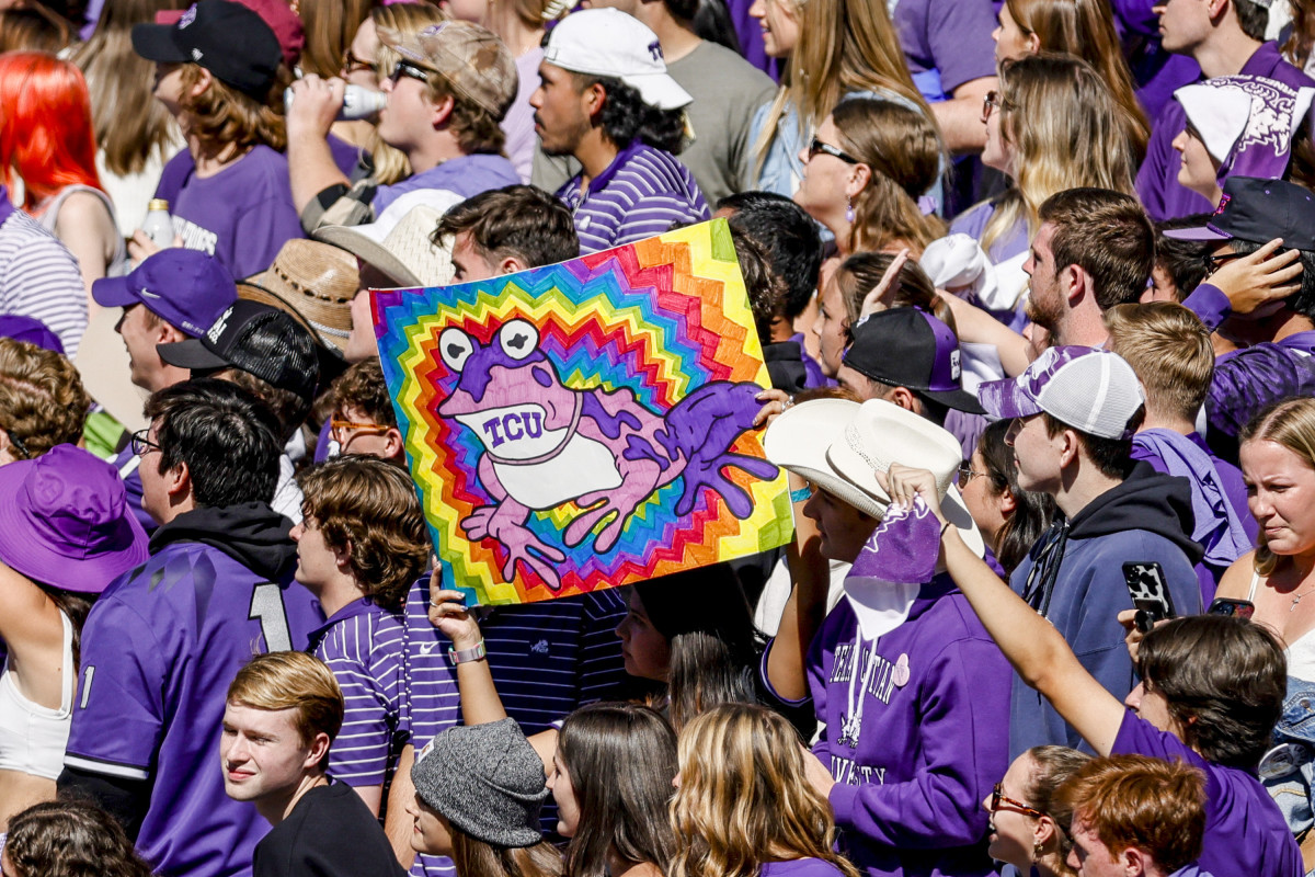 A fan holds up a Hypnotoad sign at a TCU home game.