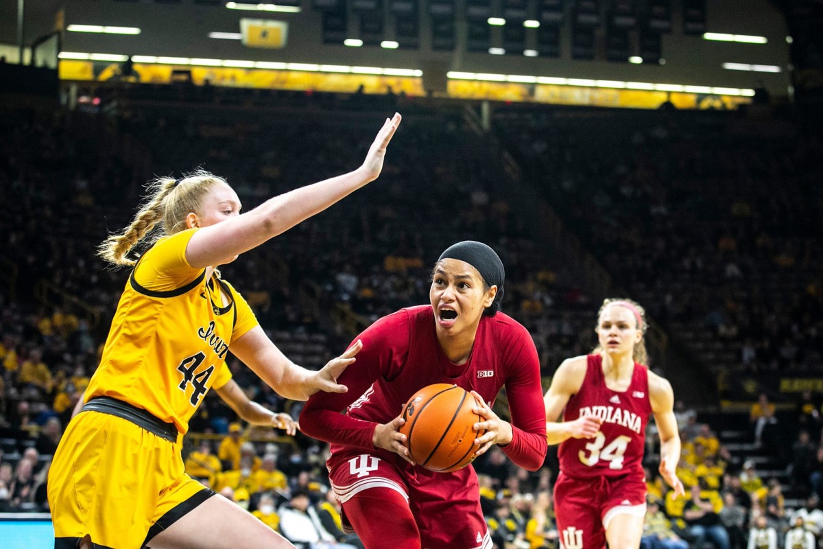 Indiana forward Kiandra Browne, center, drives to the basket against Iowa's Addison O'Grady during a NCAA Big Ten Conference women's basketball game, Monday, Feb. 21, 2022, at Carver-Hawkeye Arena in Iowa City, Iowa.