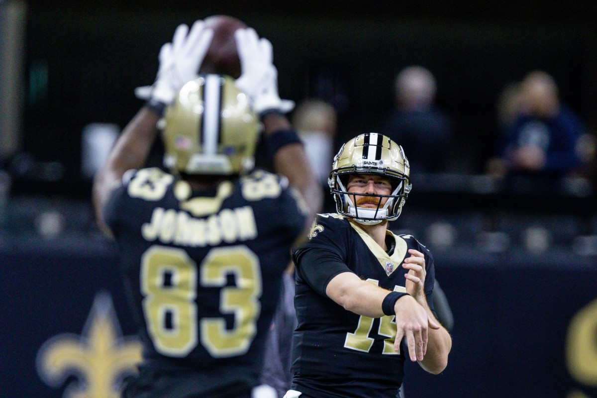 New Orleans Saints quarterback Andy Dalton (14) passes to tight end Juwan Johnson (83) during warm ups before a game against the Atlanta Falcons. Mandatory Credit: Stephen Lew-USA TODAY