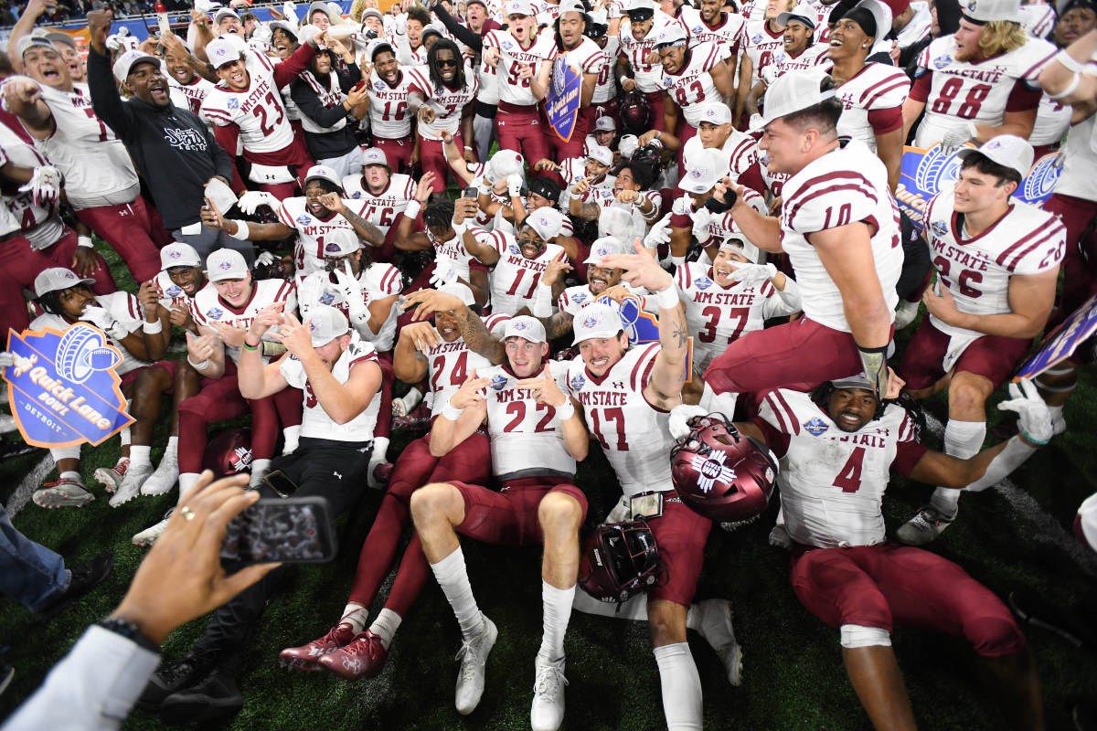 Dec 26, 2022; Detroit, Michigan, USA; New Mexico State University players celebrate their win over Bowling Green State University in the 2022 Quick Lane Bowl at Ford Field. Mandatory Credit: Lon Horwedel-USA TODAY Sports