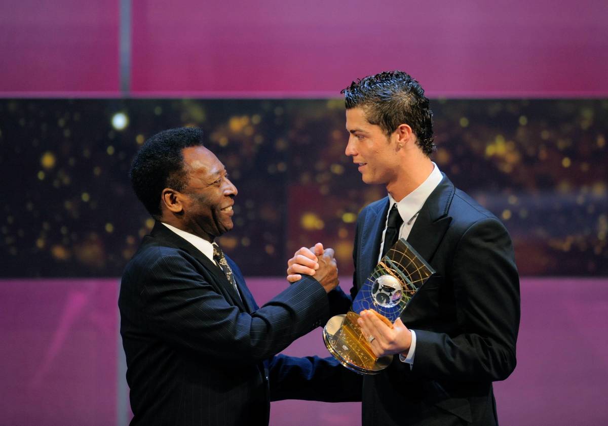 Pele (left) pictured shaking hands with Cristiano Ronaldo at an awards ceremony in 2009