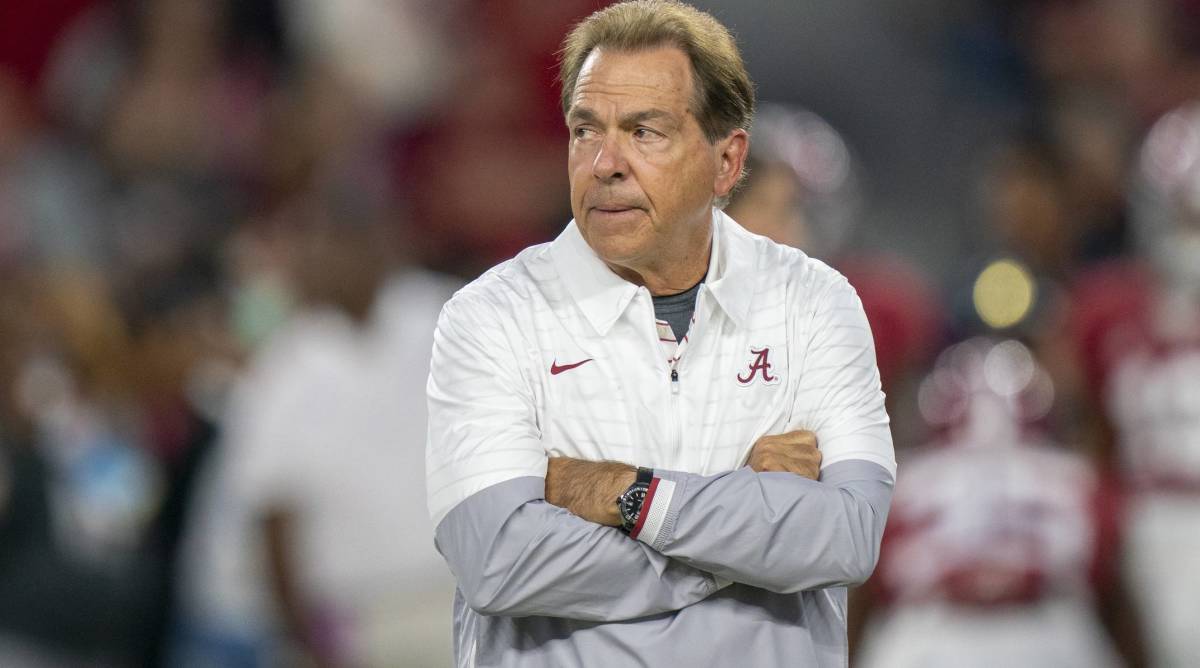 Alabama head coach Nick Saban looks on with crossed arms before a game.