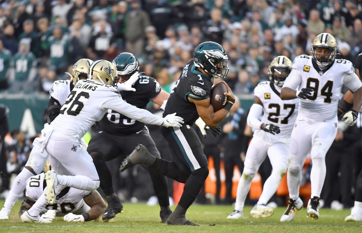 Nov 21, 2021; Philadelphia Eagles quarterback Jalen Hurts (1) runs past New Orleans Saints S P.J. Williams (26) on a 24-yard touchdown run. Mandatory Credit: Eric Hartline-USA TODAY
