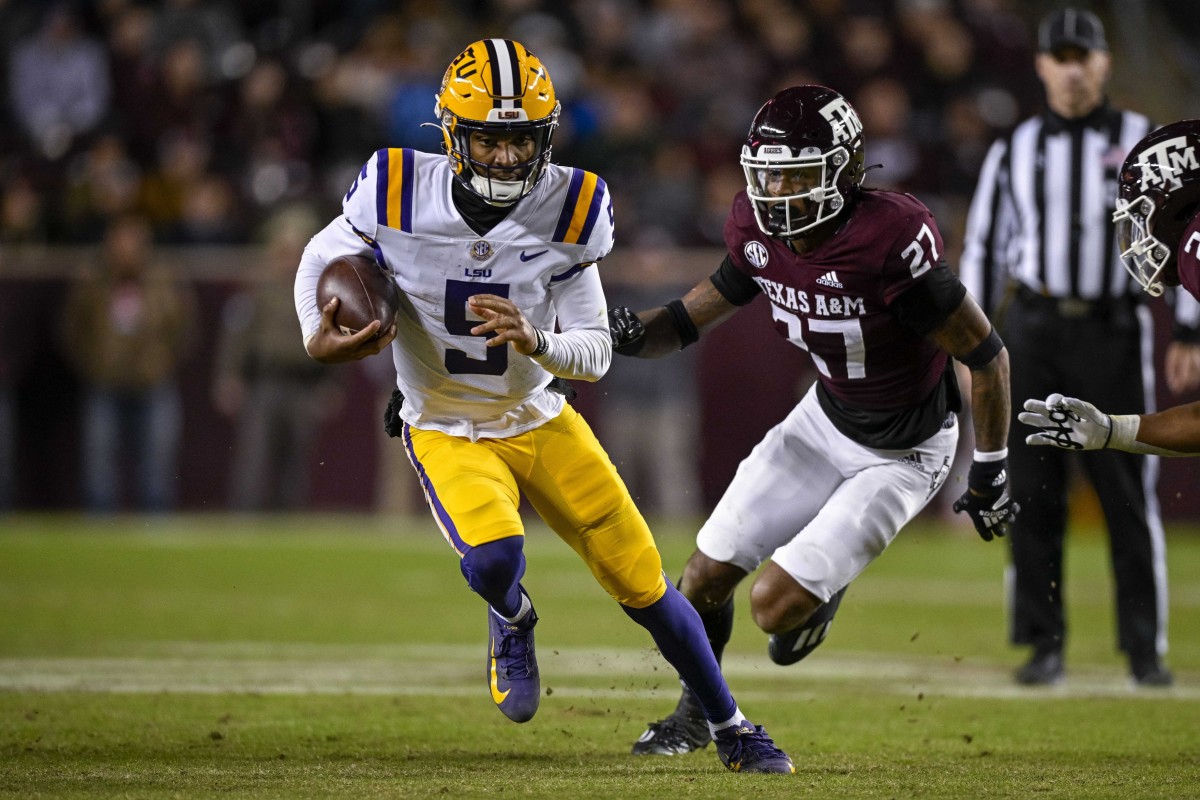 Nov 26, 2022; College Station, Texas, USA; LSU Tigers quarterback Jayden Daniels (5) and Texas A&M Aggies defensive back Antonio Johnson (27) in action during the game between the Texas A&M Aggies and the LSU Tigers at Kyle Field.